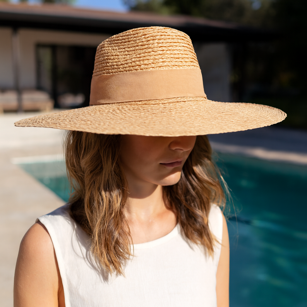 Raffia braid wide-brim fedora with suede band worn poolside