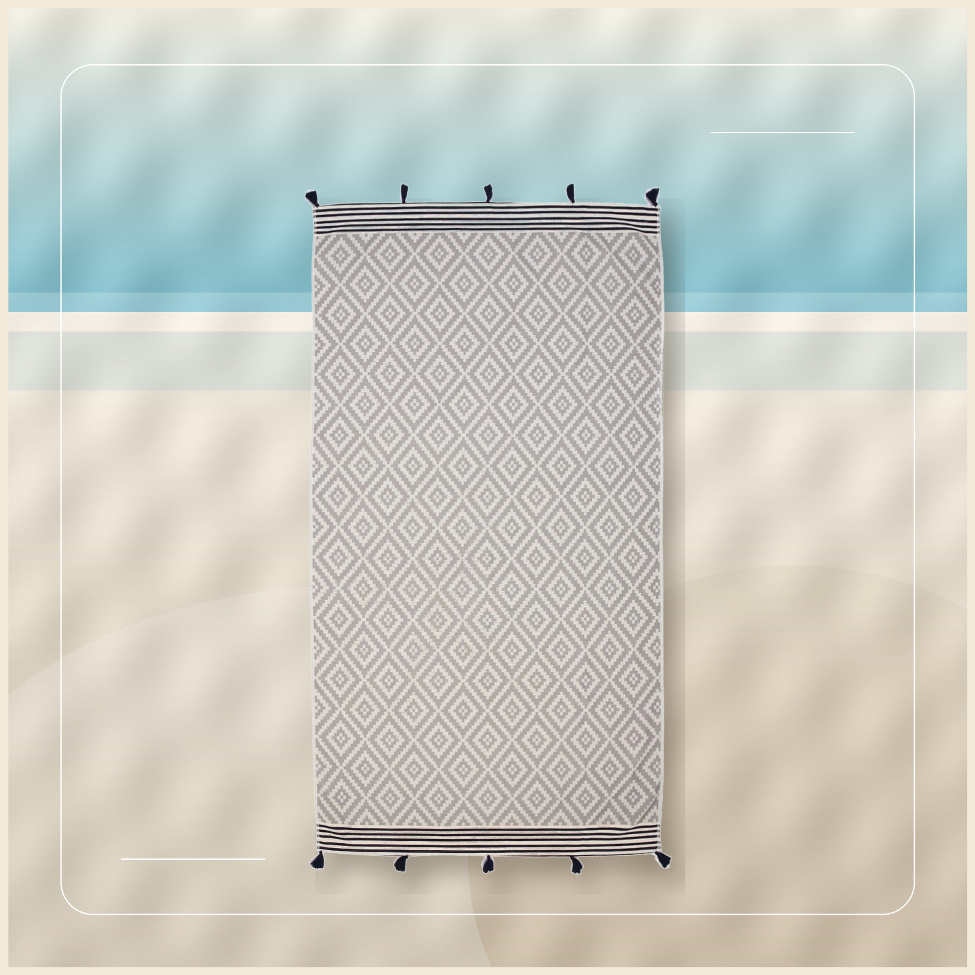 Cove Diamond Turkish Beach Blanket on a relaxed resort stone backdrop